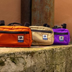 Three handlebar bags on a wall